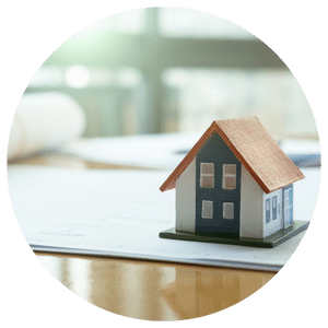 small model house on top of paper and table 