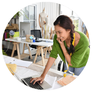 entrepreneur working on computer and talking on phone in studio