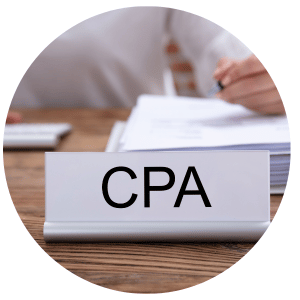 person sitting at a desk with a gray CPA name plaque